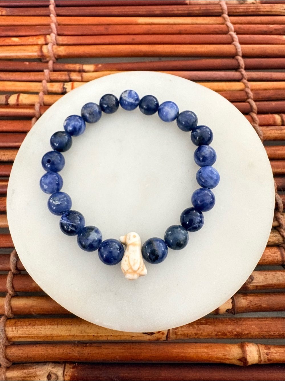 Blue Beaded Stretch Bracelet with Carved Penguin Charm